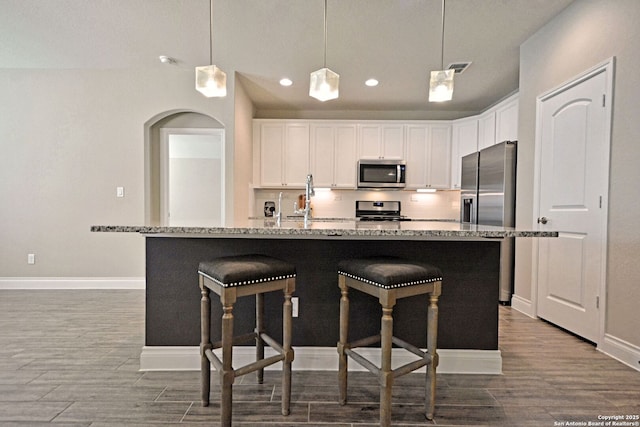 565 Rosemellow, New Braunfels, TX 78132 - kitchen with stainless steel appliances, dark wood finished floors, white cabinets, recessed lighting, and baseboards