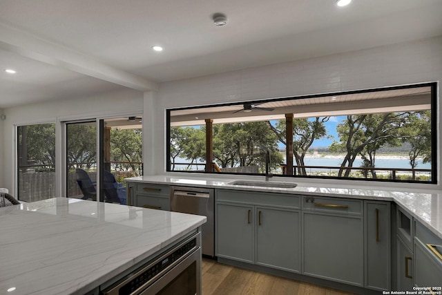 772 Lakebreeze, Canyon Lake, TX 78133 - kitchen featuring a sink, stainless steel appliances, gray cabinetry, recessed lighting, and light stone countertops