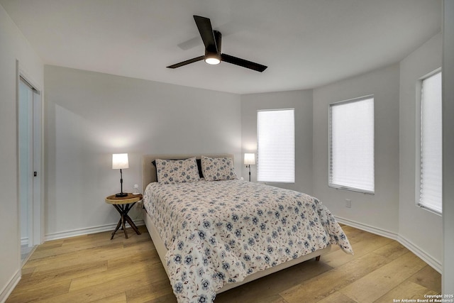 772 Lakebreeze, Canyon Lake, TX 78133 - bedroom with light wood finished floors, baseboards, and ceiling fan