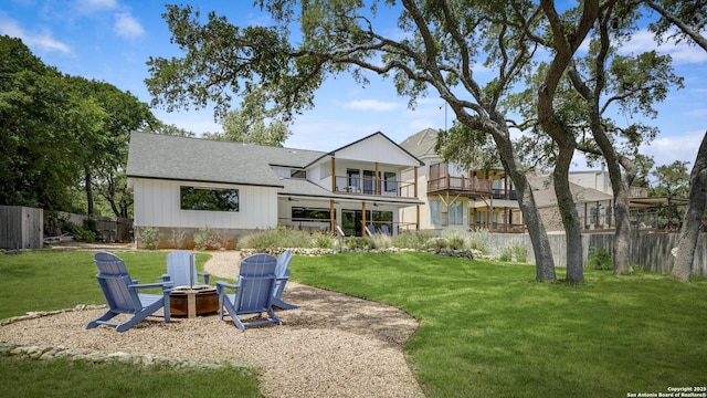 772 Lakebreeze, Canyon Lake, TX 78133 - rear view of house with an outdoor fire pit, a balcony, and a shingled roof