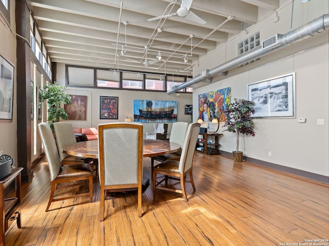 1339 S Flores St Unit 103, San Antonio, TX 78204 - dining room with wood finished floors, a ceiling fan, and track lighting