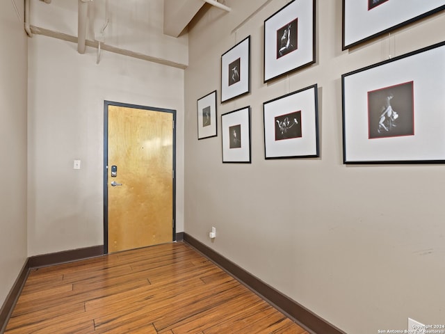 1339 S Flores St Unit 103, San Antonio, TX 78204 - doorway with baseboards and wood finished floors