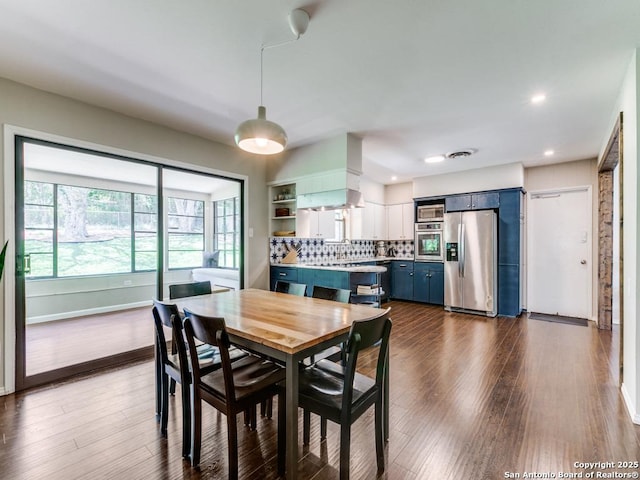 dining room with dark wood-style flooring, baseboards, and recessed lighting