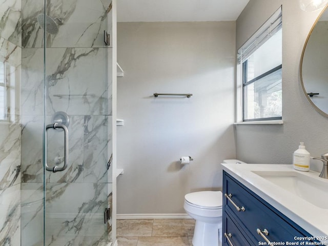 bathroom featuring a marble finish shower, vanity, toilet, and baseboards