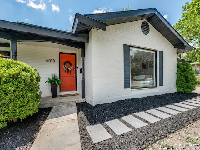 property entrance with brick siding