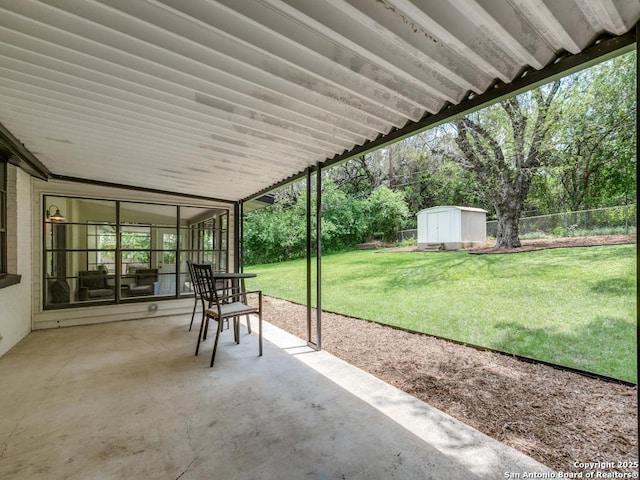 view of patio featuring a shed and an outbuilding