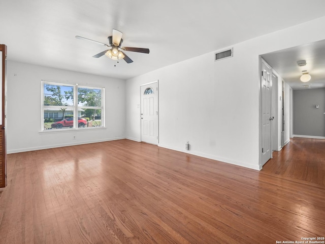 286 Goodhue, San Antonio, TX 78218 - unfurnished living room with ceiling fan, wood finished floors, and baseboards