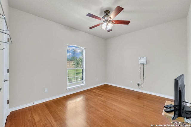 108 Medora Br, Floresville, TX 78114 - unfurnished living room featuring wood finished floors, a ceiling fan, and baseboards