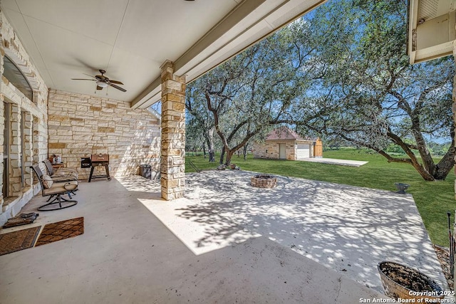 108 Medora Br, Floresville, TX 78114 - view of patio featuring ceiling fan, an outdoor structure, and an outdoor fire pit