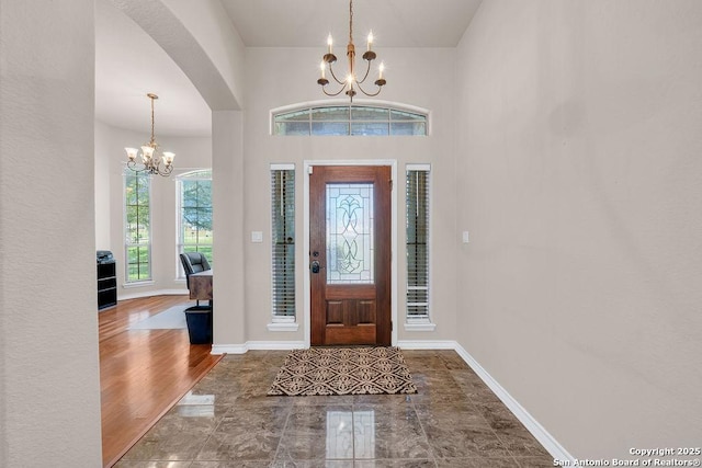 108 Medora Br, Floresville, TX 78114 - entrance foyer featuring a chandelier, arched walkways, and baseboards