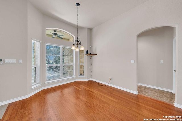 108 Medora Br, Floresville, TX 78114 - unfurnished dining area with arched walkways, wood finished floors, baseboards, and a chandelier