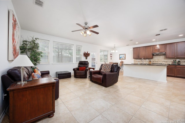 living room with ceiling fan, a chandelier, light tile patterned flooring, and recessed lighting