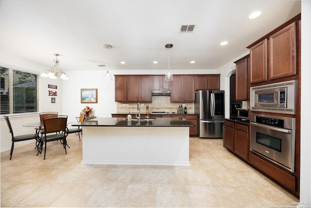 kitchen featuring appliances with stainless steel finishes, a sink, tasteful backsplash, under cabinet range hood, and light tile patterned flooring