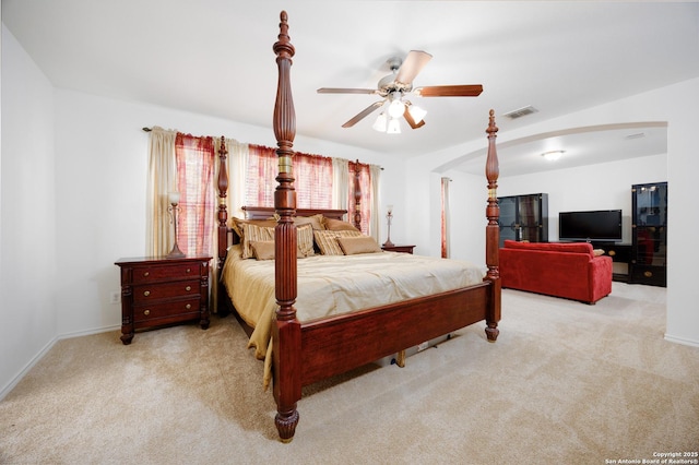 bedroom with arched walkways, carpet, baseboards, and a ceiling fan
