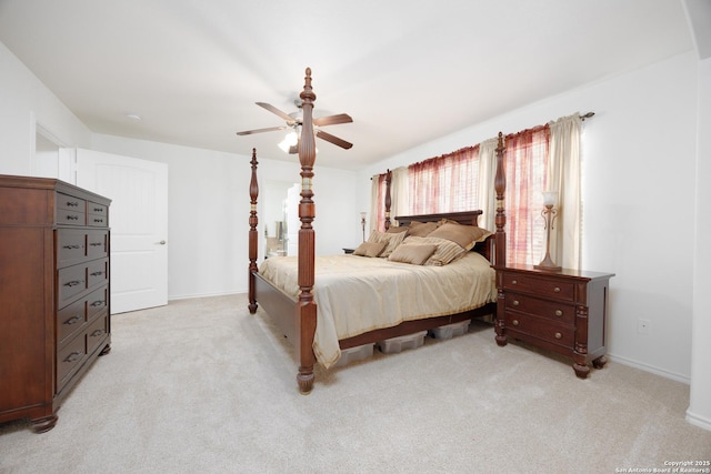 bedroom featuring light carpet, baseboards, and ceiling fan