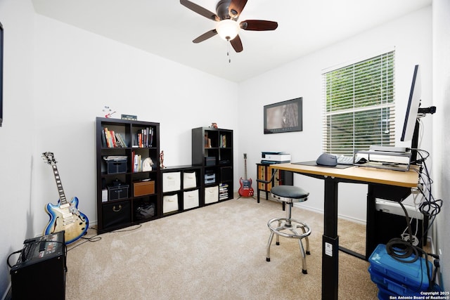 carpeted office with a ceiling fan