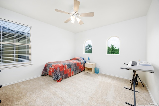 bedroom featuring carpet floors, baseboards, and a ceiling fan