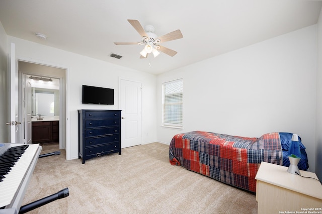 bedroom with light carpet, baseboards, ceiling fan, and a sink