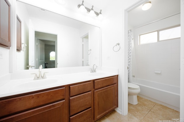 bathroom featuring toilet, tile patterned flooring, double vanity, and shower / tub combo