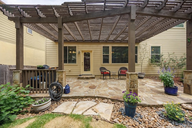 view of patio featuring fence and a pergola