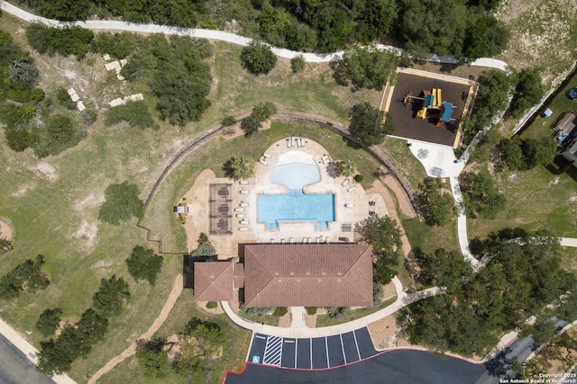 aerial view of property and surrounding area with a pool area