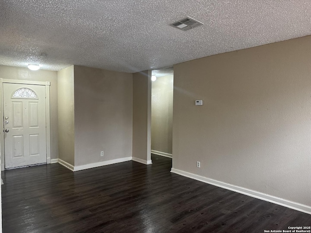 5107 Stockman Dr, San Antonio, TX 78247 - empty room with baseboards, dark wood-type flooring, and a textured ceiling