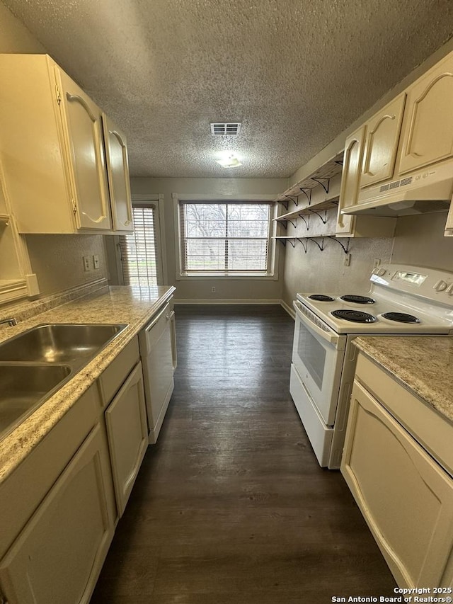 5107 Stockman Dr, San Antonio, TX 78247 - kitchen featuring white appliances, under cabinet range hood, a textured ceiling, light countertops, and dark wood finished floors