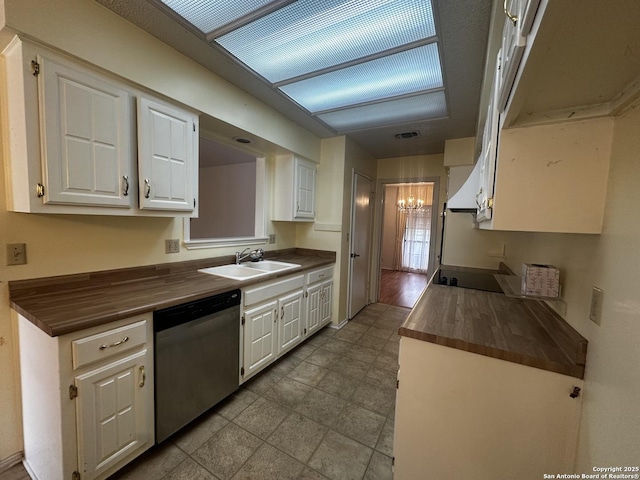 kitchen featuring dishwasher, a sink, wood counters, a chandelier, and white cabinetry