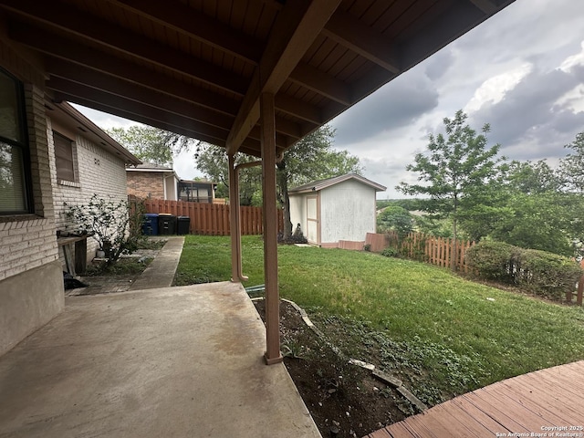view of yard with a patio, an outdoor structure, and a storage shed