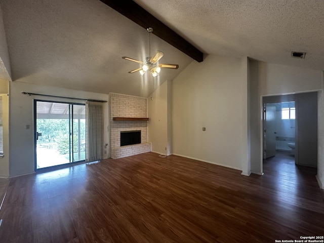 unfurnished living room featuring a ceiling fan, a textured ceiling, beam ceiling, dark wood-style flooring, and a fireplace