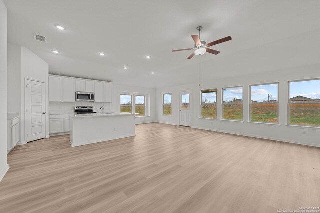 101 Cheyenne Dr, Floresville, TX 78114 - unfurnished living room with ceiling fan, recessed lighting, light wood-type flooring, a sink, and baseboards
