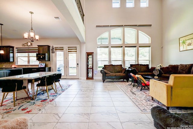 4019 Wood Crk, San Antonio, TX 78257 - living room with light marble finish flooring, a chandelier, and a towering ceiling