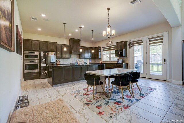 4019 Wood Crk, San Antonio, TX 78257 - dining area with light marble finish floors, recessed lighting, a chandelier, arched walkways, and baseboards