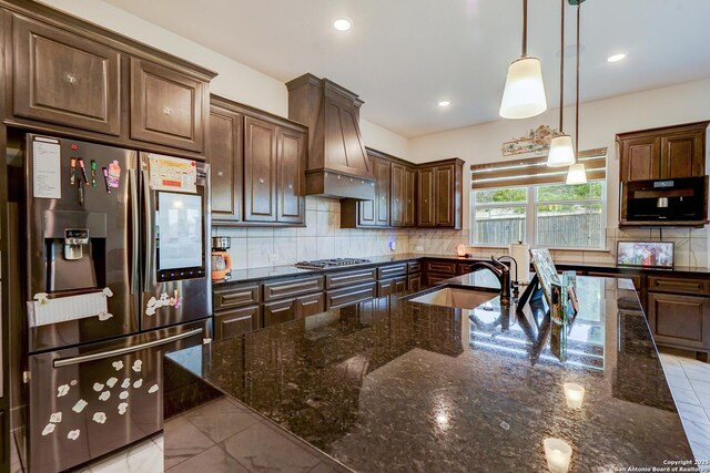 4019 Wood Crk, San Antonio, TX 78257 - kitchen with stainless steel fridge, a sink, custom range hood, tasteful backsplash, and decorative light fixtures