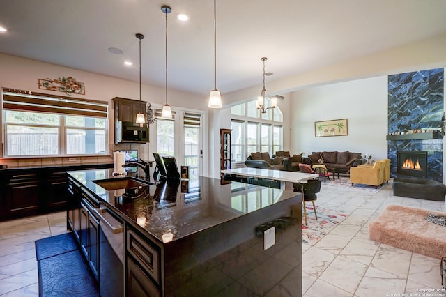 4019 Wood Crk, San Antonio, TX 78257 - kitchen featuring a sink, stainless steel dishwasher, an island with sink, a premium fireplace, and open floor plan
