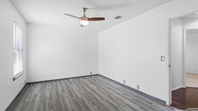 154 Sassafras, Kyle, TX 78640 - spare room featuring wood finished floors, ceiling fan, and baseboards