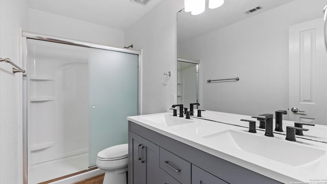 154 Sassafras, Kyle, TX 78640 - bathroom featuring toilet, a stall shower, and double vanity