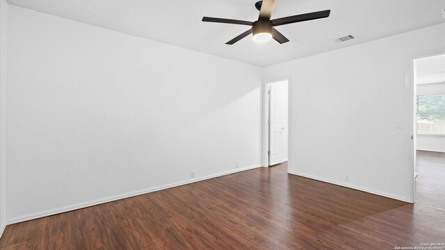 154 Sassafras, Kyle, TX 78640 - spare room featuring a ceiling fan, dark wood-type flooring, and baseboards