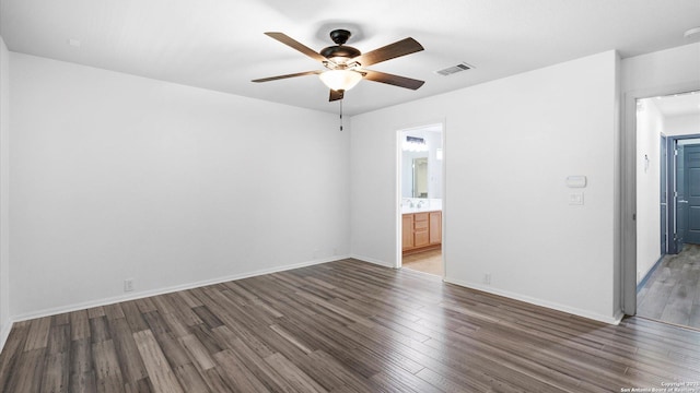 154 Sassafras, Kyle, TX 78640 - empty room featuring a ceiling fan, wood finished floors, and baseboards