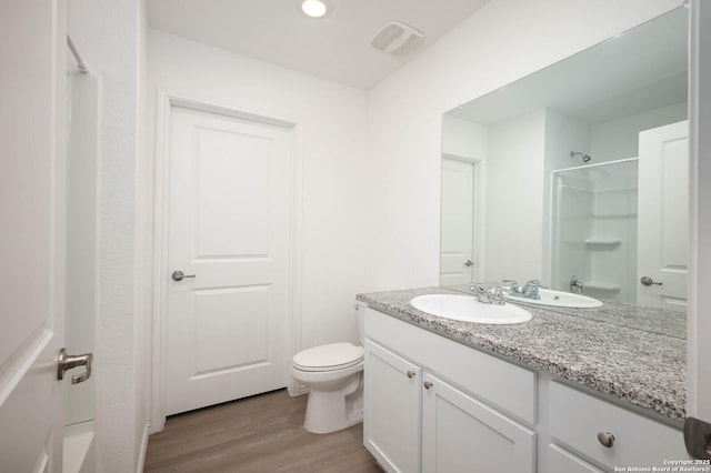 12023 Picard, San Antonio, TX 78221 - bathroom with toilet, wood finished floors, and vanity