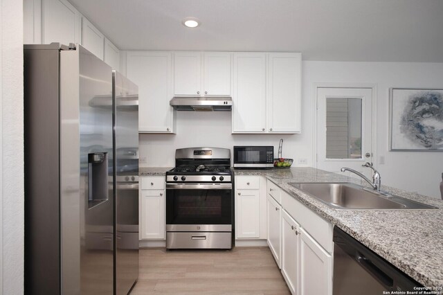 12023 Picard, San Antonio, TX 78221 - kitchen featuring appliances with stainless steel finishes, under cabinet range hood, a sink, white cabinetry, and recessed lighting