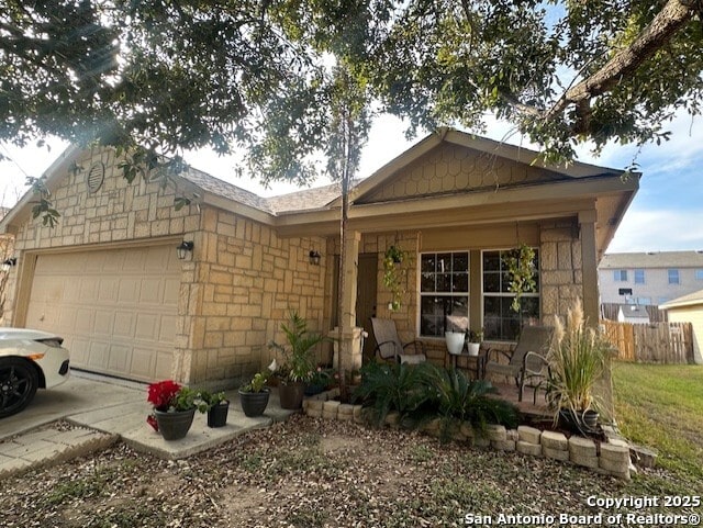 351 Fontana Albero, San Antonio, TX 78253 - ranch-style home featuring an attached garage, stone siding, fence, and driveway