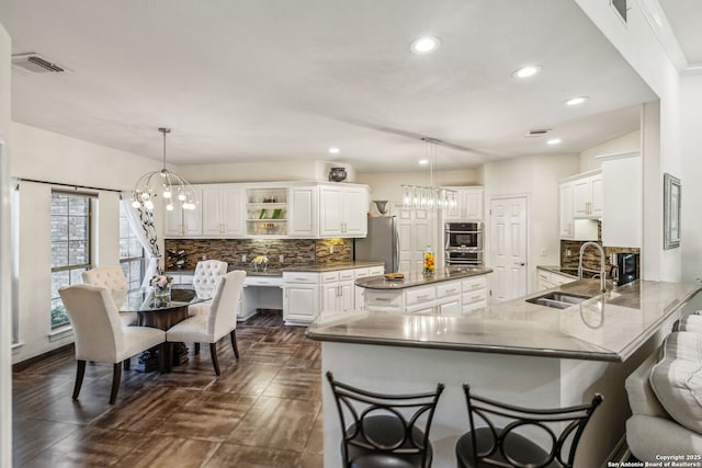 24 Rogers Wood, San Antonio, TX 78248 - kitchen with a sink, a chandelier, open shelves, tasteful backsplash, and recessed lighting