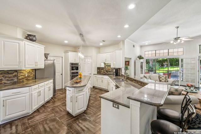24 Rogers Wood, San Antonio, TX 78248 - kitchen featuring a sink, tasteful backsplash, a peninsula, ceiling fan, and recessed lighting