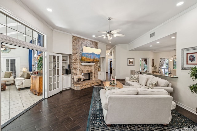 24 Rogers Wood, San Antonio, TX 78248 - living room with ceiling fan, ornamental molding, healthy amount of natural light, a brick fireplace, and recessed lighting