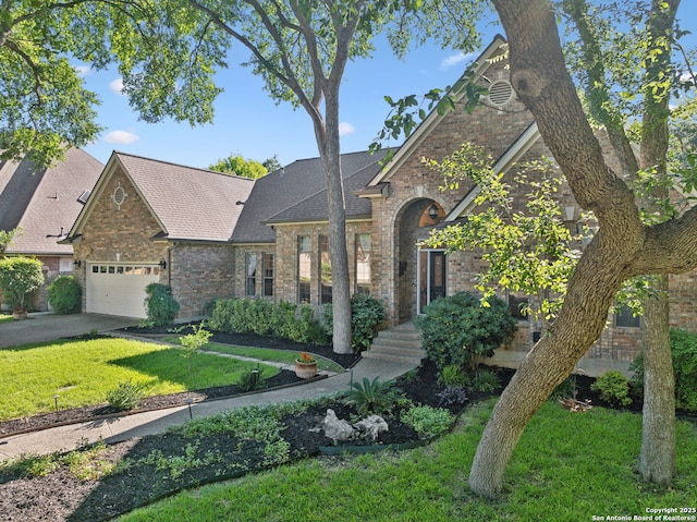 24 Rogers Wood, San Antonio, TX 78248 - view of front of property with brick siding, a front lawn, an attached garage, a shingled roof, and driveway