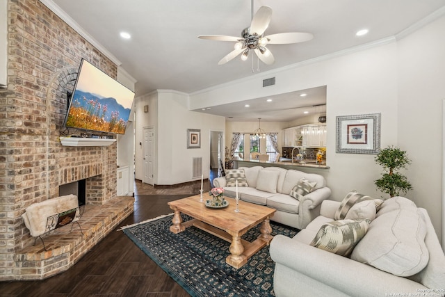 24 Rogers Wood, San Antonio, TX 78248 - living area with crown molding, ceiling fan, a brick fireplace, dark wood finished floors, and recessed lighting