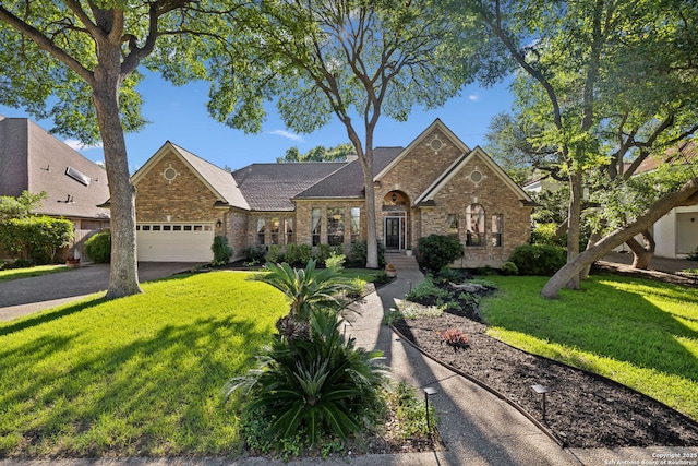 24 Rogers Wood, San Antonio, TX 78248 - view of front facade with an attached garage, a front lawn, driveway, stone siding, and brick siding
