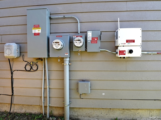 11719 Claudette St, San Antonio, TX 78252 - utility room featuring electric meter