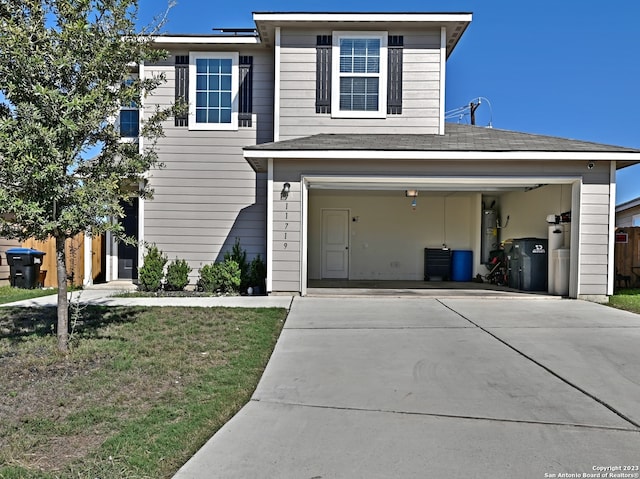 11719 Claudette St, San Antonio, TX 78252 - traditional-style house featuring concrete driveway, water heater, a front yard, and an attached garage